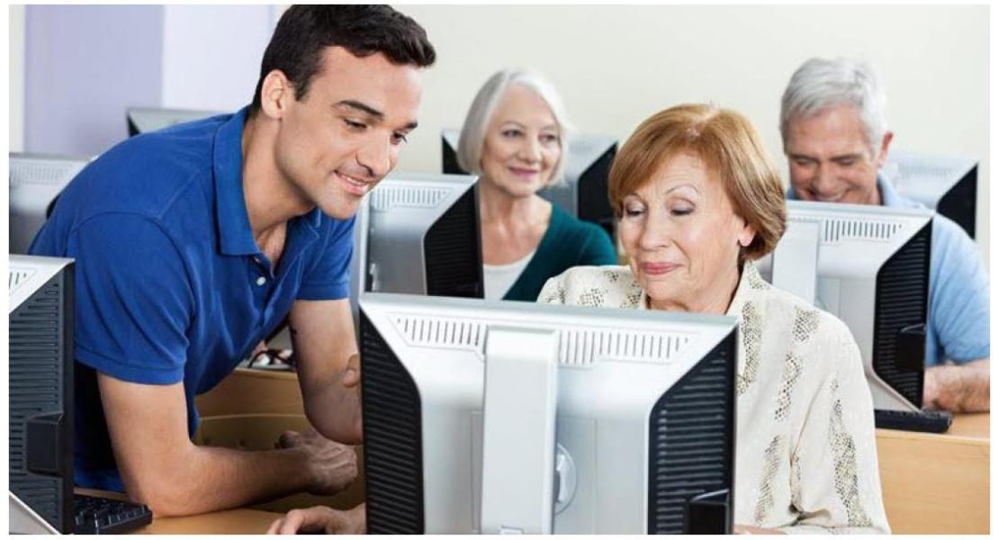 Image of staff helping a person at a computer