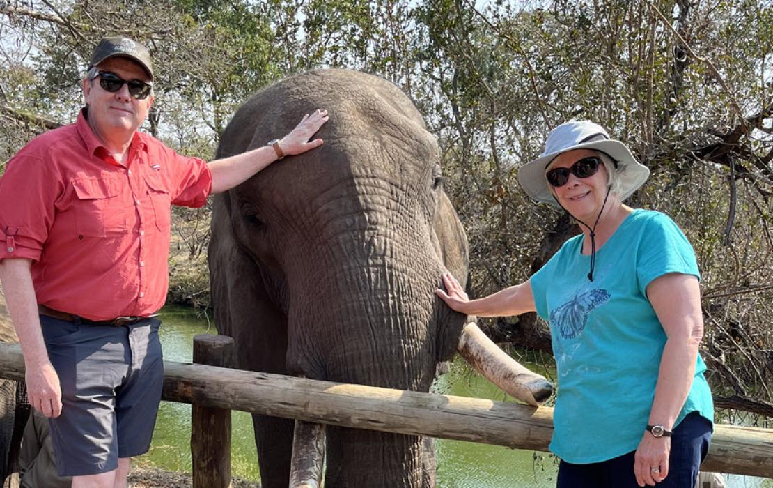 Image of Pat and Karen petting an elephant